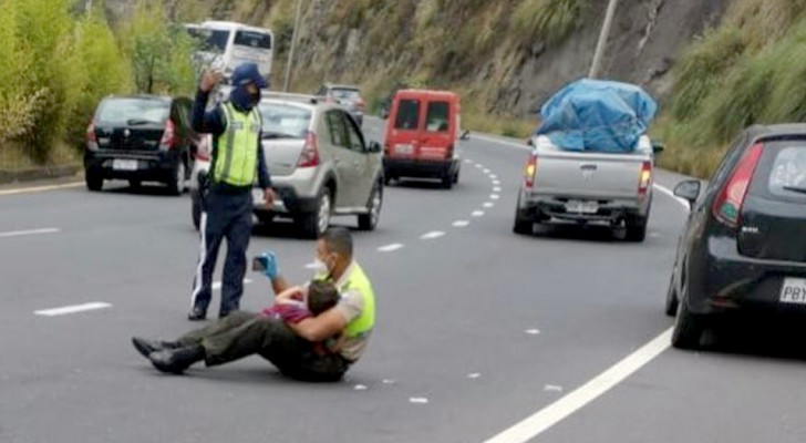 Nuotrauka, kurioje užfiksuotas policininkas, sėdintis vidury kelio su vaiku, suvirpino tūkstančių žmonių širdis